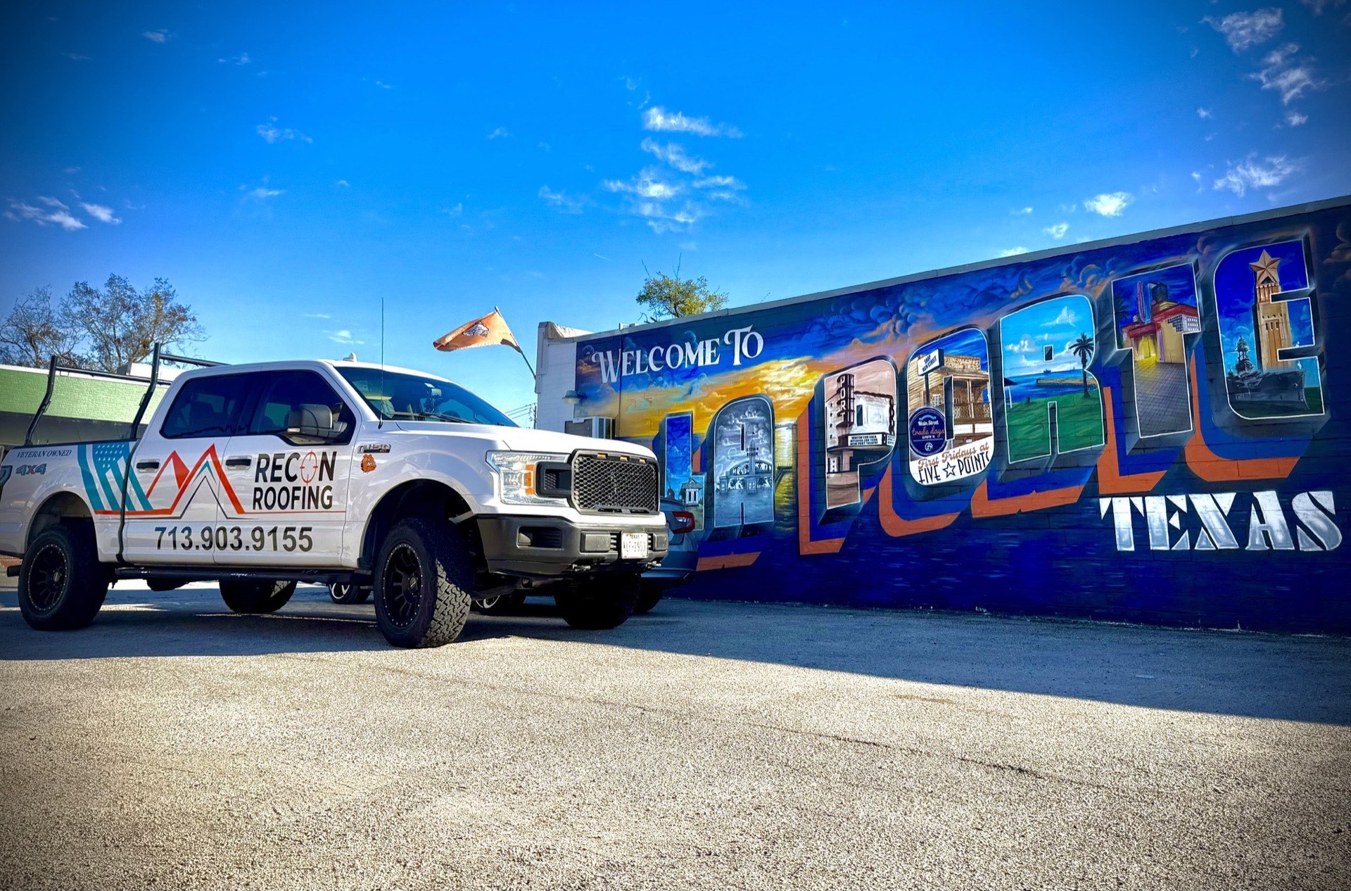 Recon Roofing truck in front of the Welcome to La Porte, Texas mural