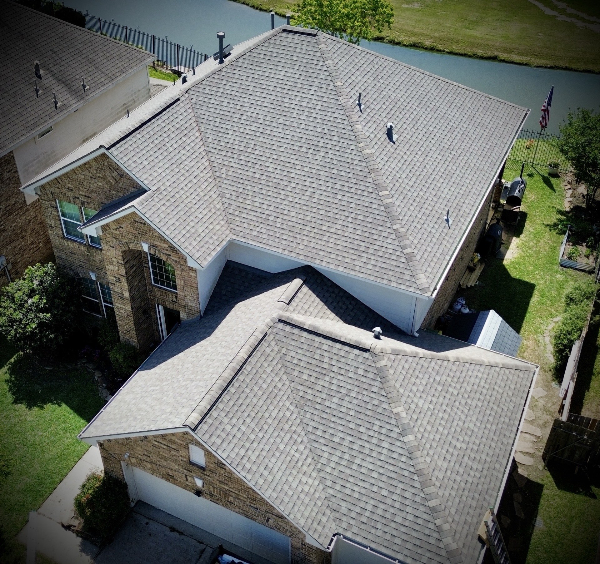 New shingle roof installed by Recon Roofing on a lakeside home near La Porte, TX